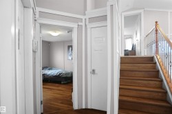 Wood-finish flooring extends from the hallway into an open room - 