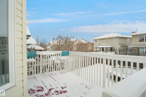 Upper-level exterior deck featuring white railing and siding - 4816 155 Ave, Edmonton, AB 