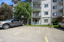 2 out of 2 paved parking marked stalls with electricity is bordered by mature trees. - 