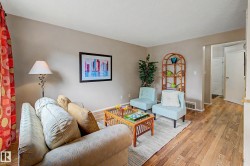 Open concept living area featuring wood-finish flooring, neutral wall tones, and recessed lighting - 