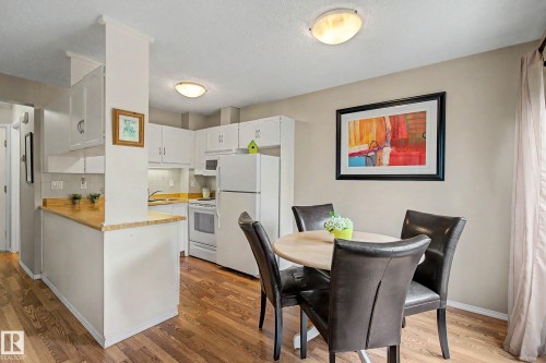 Open-concept kitchen and dining area featuring wood-finish flooring - 19 Pineview Drive, St. Albert, AB 