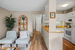 Kitchen featuring white cabinetry, a built-in microwave, and wood-finish countertops - 