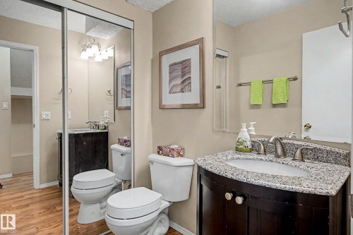 Bathroom featuring a dark wood vanity with a granite countertop and an undermount sink - 19 Pineview Drive, St. Albert, AB 