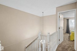 Interior staircase with white balusters and newel posts - 