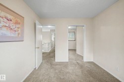 Carpeted room with neutral wall color - 