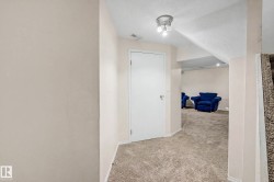 Carpeted flooring throughout, recessed lighting, and a white interior door with a round knob - 