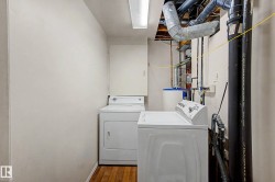 Dedicated laundry area featuring a top-load washing machine and front-load dryer - 