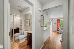 Bathroom with a dark wood vanity, light countertop, and mirrored sliding closet doors - 