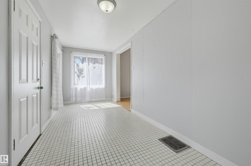 Entryway featuring white square tile flooring and light grey wall finishes - 11450 71 Street Nw, Edmonton, AB 