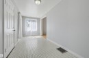 Entryway featuring white square tile flooring and light grey wall finishes - 11450 71 Street Nw, Edmonton, AB 