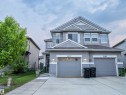 Contemporary duplex featuring a light gray siding exterior with white trim - 5407 14 Avenue, Edmonton, AB 