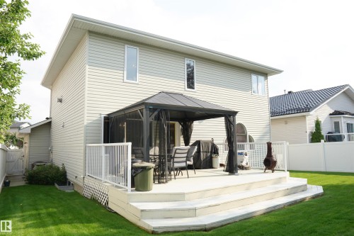 Expansive rear deck featuring multiple steps, white railings, and a screened gazebo - 8504 160A Avenue, Edmonton, AB 
