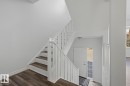 Staircase entry featuring wood-finish treads and white risers - 6 1237 Carter Crest Road, Edmonton, AB 