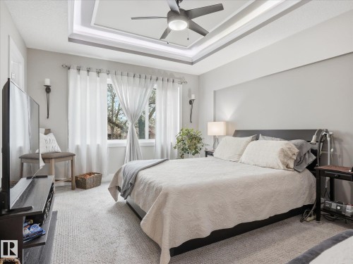 Tray ceiling with recessed lighting and a ceiling fan - 12820 68 Street, Edmonton, AB - Indoor Photo Showing Bedroom