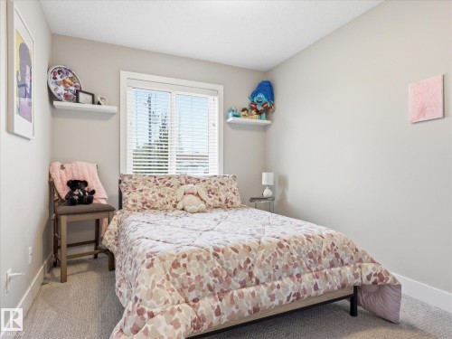 Bedroom featuring neutral wall paint, white trim, and light gray carpeting - 12820 68 Street, Edmonton, AB - Indoor Photo Showing Bedroom
