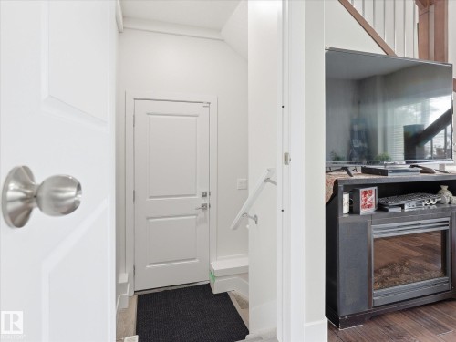 Entryway featuring a white paneled door with brushed nickel hardware - 12820 68 Street, Edmonton, AB - Indoor Photo Showing Other Room