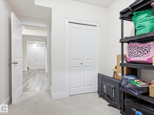 Hallway featuring light gray carpeting, white baseboards, and a white bi-fold closet door - 12820 68 Street, Edmonton, AB - Indoor Photo Showing Bedroom