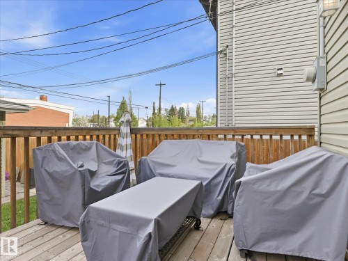 Expansive wood-finish deck with a wood railing, offering outdoor living space - 12820 68 Street, Edmonton, AB - Outdoor With Deck Patio Veranda With Exterior