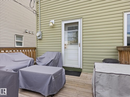 Exterior deck featuring wood-finish flooring and a white glass-paneled door - 12820 68 Street, Edmonton, AB - Outdoor With Deck Patio Veranda With Exterior