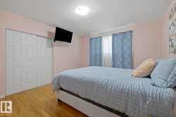 Warm-toned wood-finish flooring complements light-colored walls - 