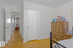Hardwood-style flooring extends through the hallway and into the room - 
