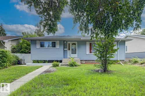 Light blue vinyl siding exterior with white window shutters - 15707 92 Avenue, Edmonton, AB 
