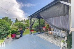 Deck featuring a blue wood-finish surface and a gazebo with mesh screening - 
