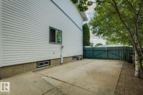 White vinyl siding exterior with a concrete patio - 3015 131 Avenue, Edmonton, AB 