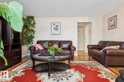 Warm-toned interior featuring wood-finish flooring and light-painted walls - 3015 131 Avenue, Edmonton, AB 