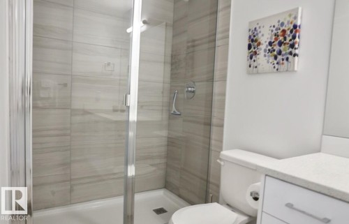 Glass-enclosed shower with large format tile surround - 216 11503 76 Avenue, Edmonton, AB 