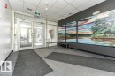 Building entrance featuring glass double doors, sidelights, transom windows, and a dropped ceiling with recessed lighting - 216 11503 76 Avenue, Edmonton, AB 