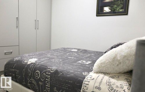 Integrated wardrobe cabinetry featuring multiple doors and a lower drawer - 216 11503 76 Avenue, Edmonton, AB 
