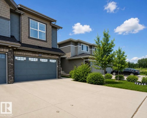 Multi-textured exterior featuring board and batten, shake, and stone veneer accents - 12737 205 Street Nw, Edmonton, AB 