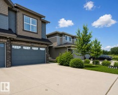 Multi-textured exterior featuring board and batten, shake, and stone veneer accents - 