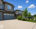 Multi-textured exterior featuring board and batten, shake, and stone veneer accents - 12737 205 Street Nw, Edmonton, AB 