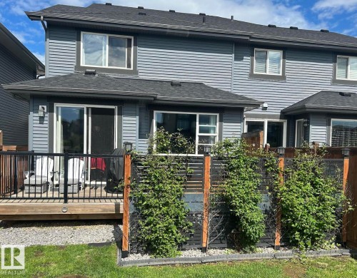 Rear exterior with gray horizontal siding and black trim details - 12737 205 Street Nw, Edmonton, AB 