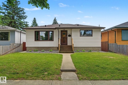 Single-story residence featuring white horizontal siding and a dark brown roof - 9545 65 Avenue, Edmonton, AB 