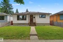 Single-story residence featuring white horizontal siding and a dark brown roof - 9545 65 Avenue, Edmonton, AB 