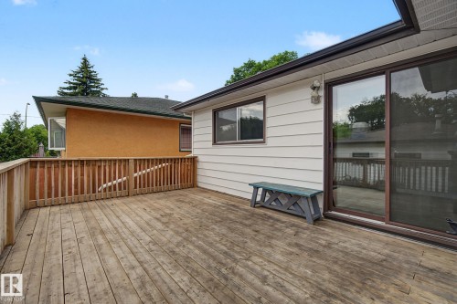 Expansive outdoor deck with wood railing - 9545 65 Avenue, Edmonton, AB 