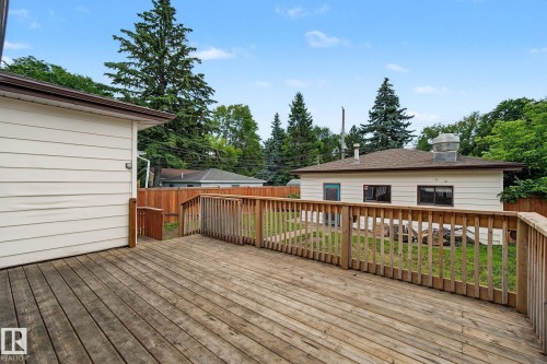 Expansive wood deck with a perimeter railing - 9545 65 Avenue, Edmonton, AB 