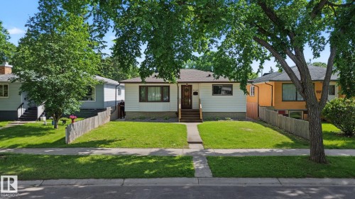 Bungalow residence featuring white siding and a dark roof - 9545 65 Avenue, Edmonton, AB 