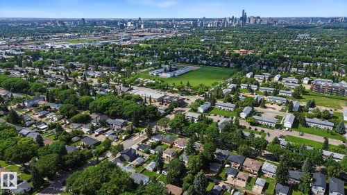 Aerial perspective showcasing a residential area with varied housing styles and abundant mature trees - 9545 65 Avenue, Edmonton, AB 