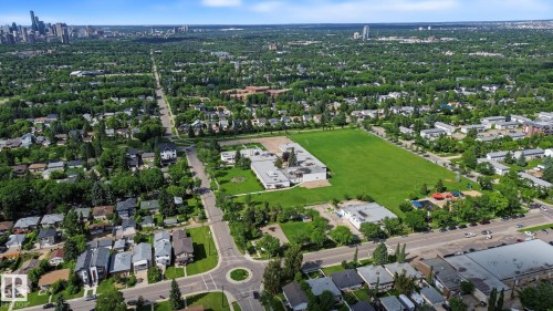 Expansive green space featuring a large sports field and adjacent school building - 9545 65 Avenue, Edmonton, AB 