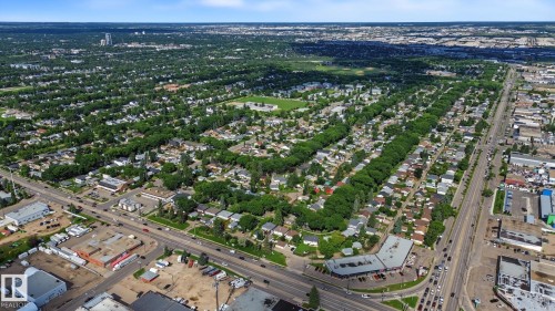Expansive aerial perspective showcasing a residential area with abundant mature trees and a network of roadways - 9545 65 Avenue, Edmonton, AB 