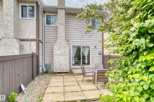 Rear patio with square paver stones, surrounded by pea gravel - 173 Tudor Lane, Edmonton, AB 
