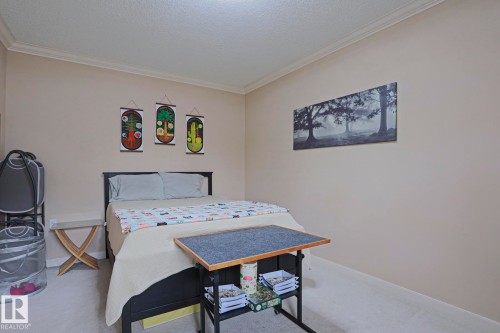 Carpeted room with neutral wall paint and crown molding - 13 7293 South Terwillegar Drive, Edmonton, AB 
