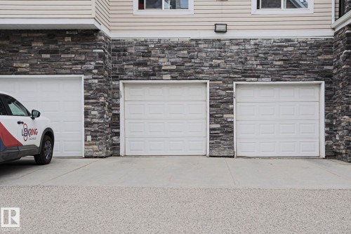 Exterior featuring stacked stone facade and horizontal siding - 13 7293 South Terwillegar Drive, Edmonton, AB 