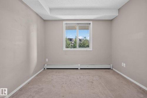 Neutral-toned walls complement the window with horizontal blinds - 205 11816 22 Avenue, Edmonton, AB 