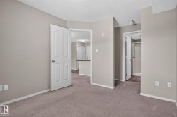 Neutral-toned walls complement the textured ceiling - 