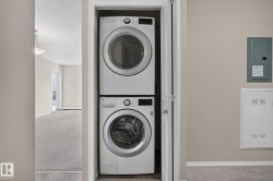 Dedicated laundry closet featuring a stacked washer and dryer - 